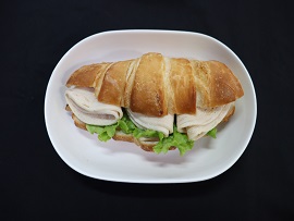 Chicken Lyoner knots in croissant + water